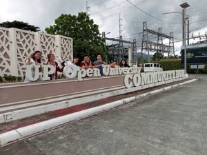 ProvComm Members in front of the UPOU Community Hub Sign