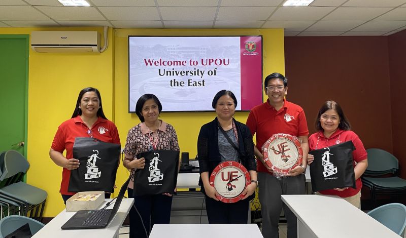 Dr. Myra C. Almodiel (center), Director of the UPOU Office of Public Affairs, with the visitors from the University of the East.