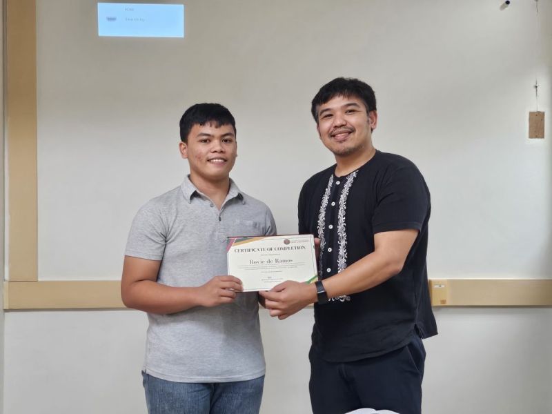 Rovie de Ramos receiving his certificate of completion for internship.